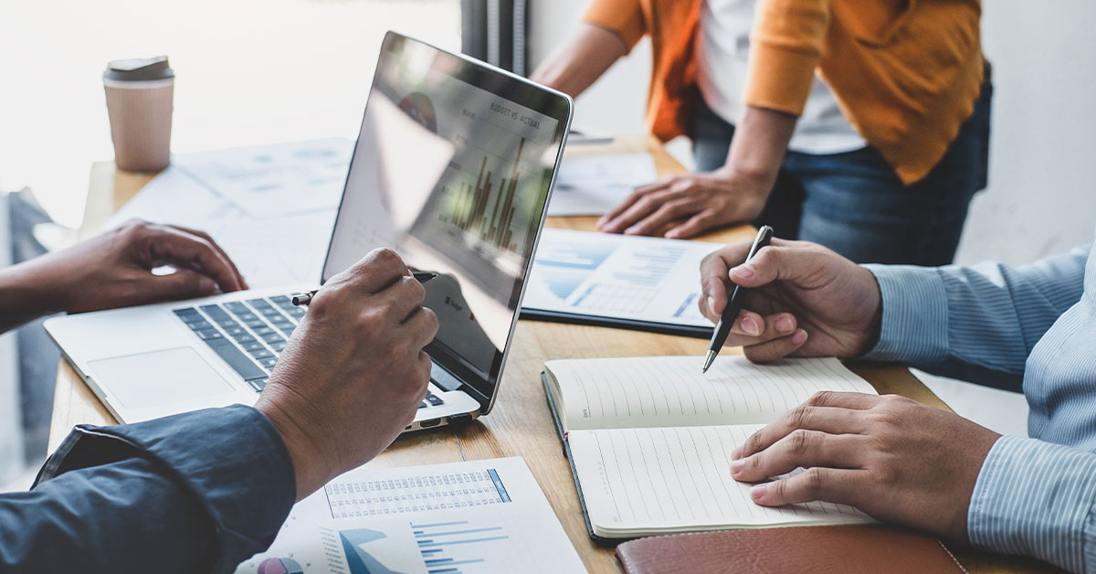 a man sitting at a table using a laptop